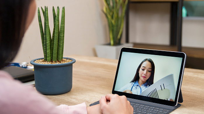 Woman on a virtual wellness screening via tablet device